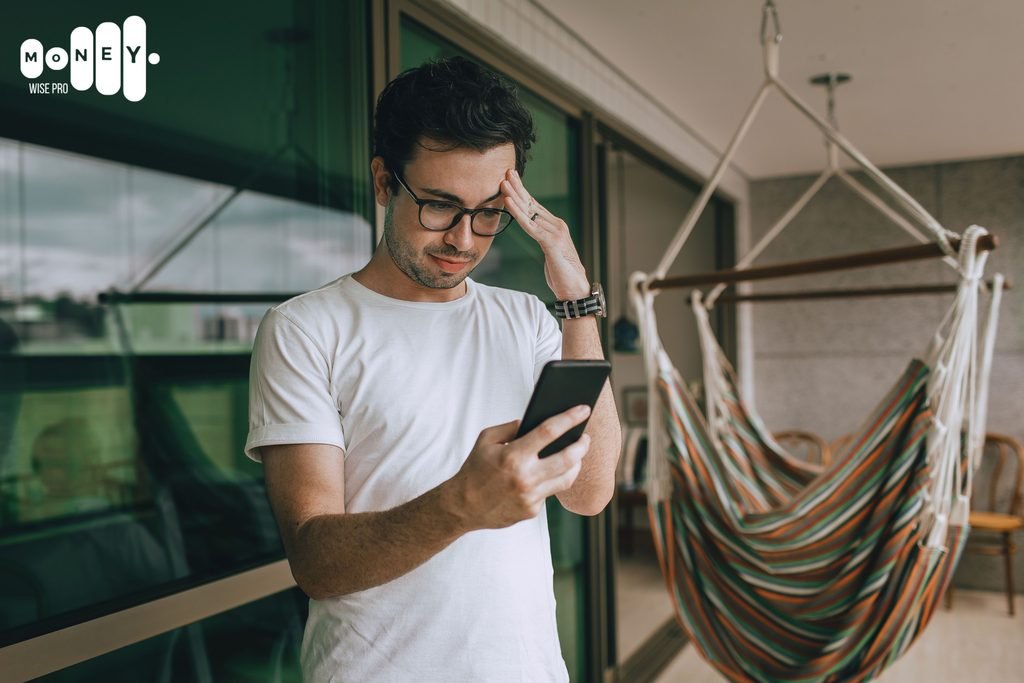 Person checking a banking app and noticing a surprise overdraft fee alert