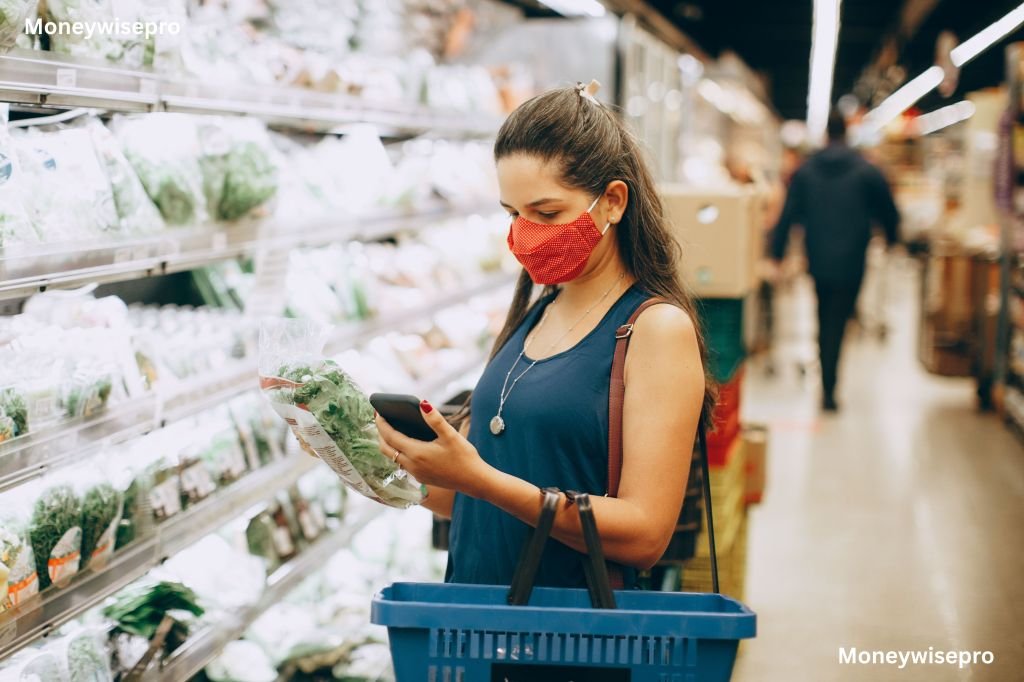 A young woman comparing grocery prices on a phone app in a supermarket aisle