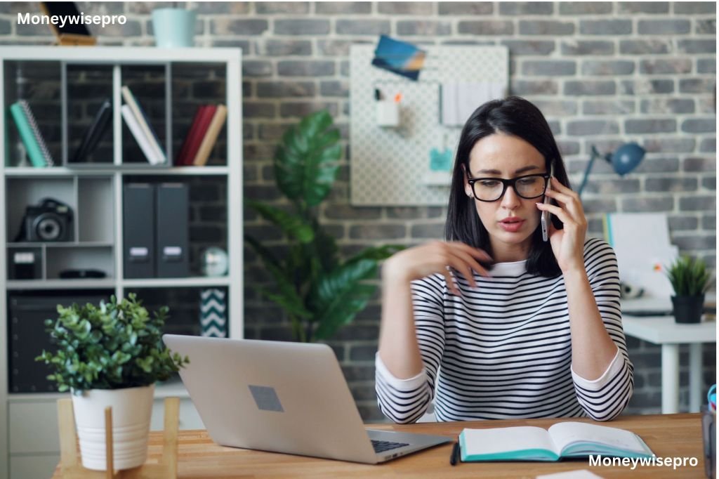 A frustrated woman on the phone while looking at a gym membership cancellation page on her laptop