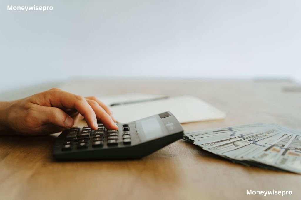 A calculator sits next to unpaid bills as someone works out a monthly repayment budget.