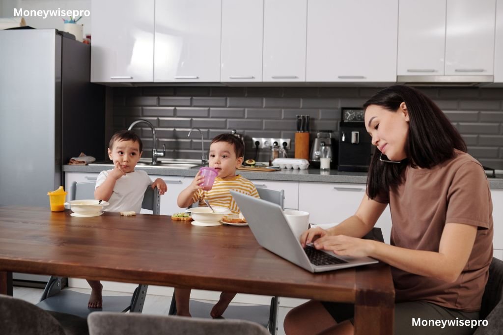Young mother reading a rental agreement on laptop at a kitchen table with a toddler nearby