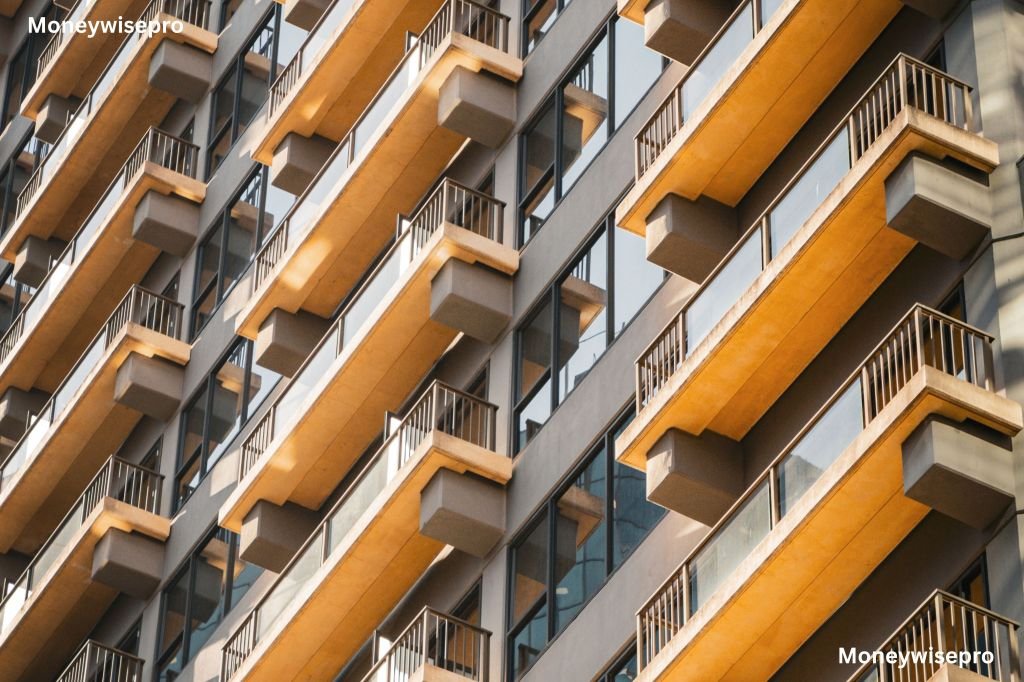 Modern apartment building exterior showing multiple rows of balconies against a clear sky