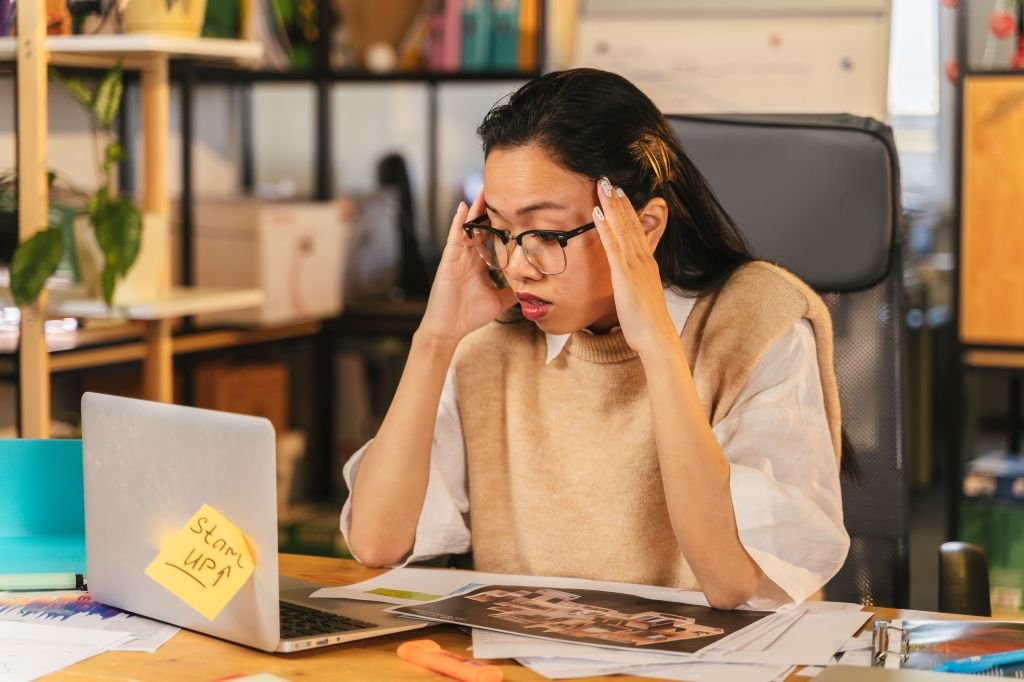 stressed person looking at laptop