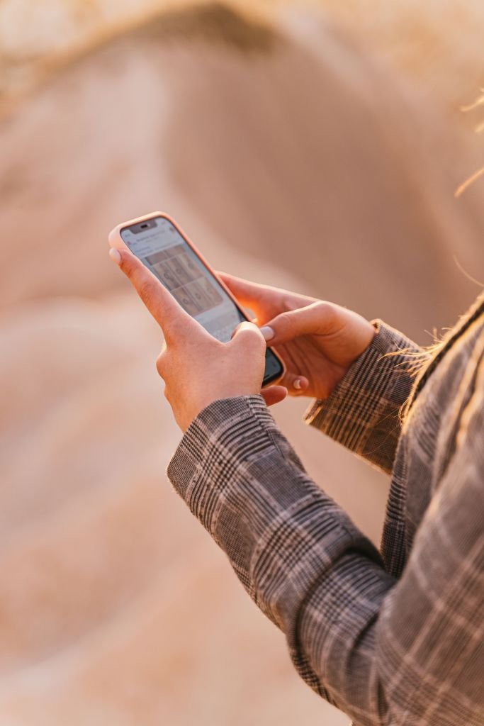  someone checking a bank app on their phone, looking a little worried