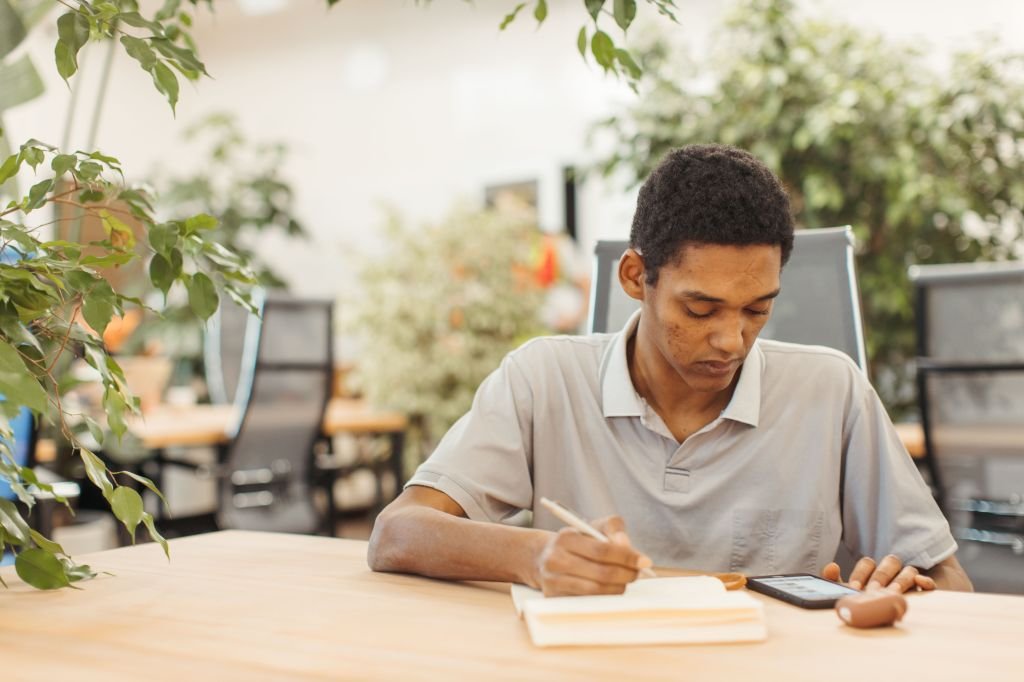 calm person writing in a notebook