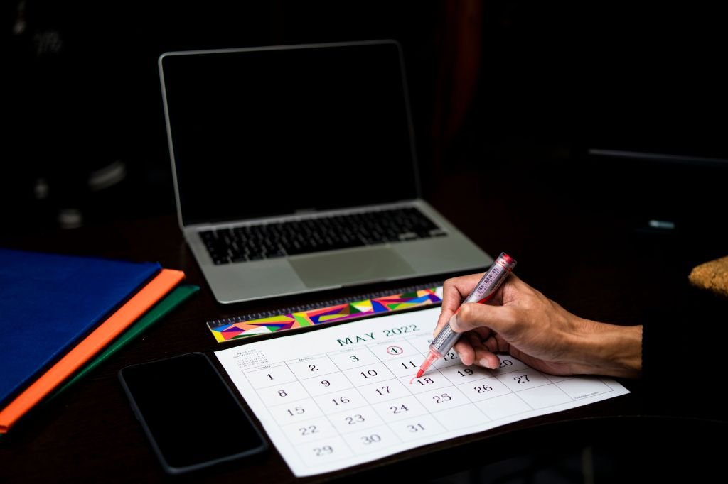 Person checking calendar or phone for upcoming payment due dates, staying organized