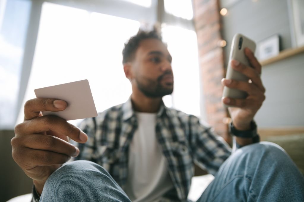 Person looking anxious while holding phone with payment app