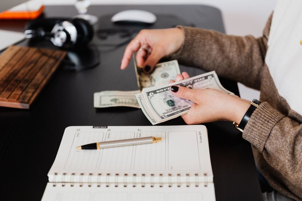  a simple handwritten budget list on a notebook
