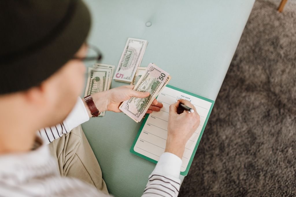 Person confidently managing finances and taking control of budget