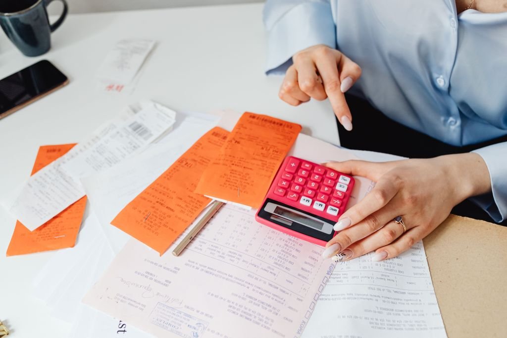 Calculator and bills showing hidden bank fees adding up