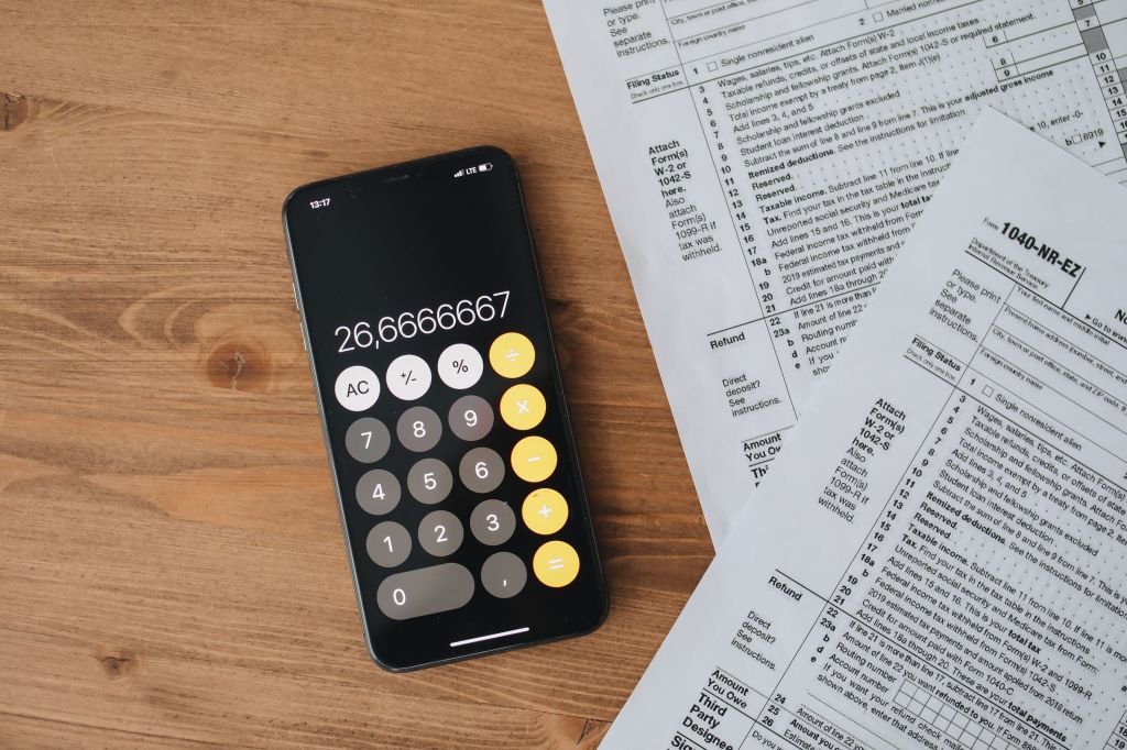 A paycheck next to a calculator, representing how the overtime tax deduction is actually calculated