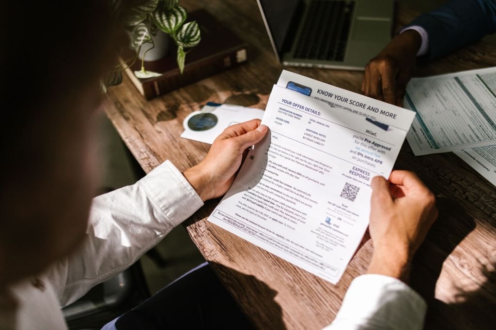 Person carefully reviewing credit report statement 