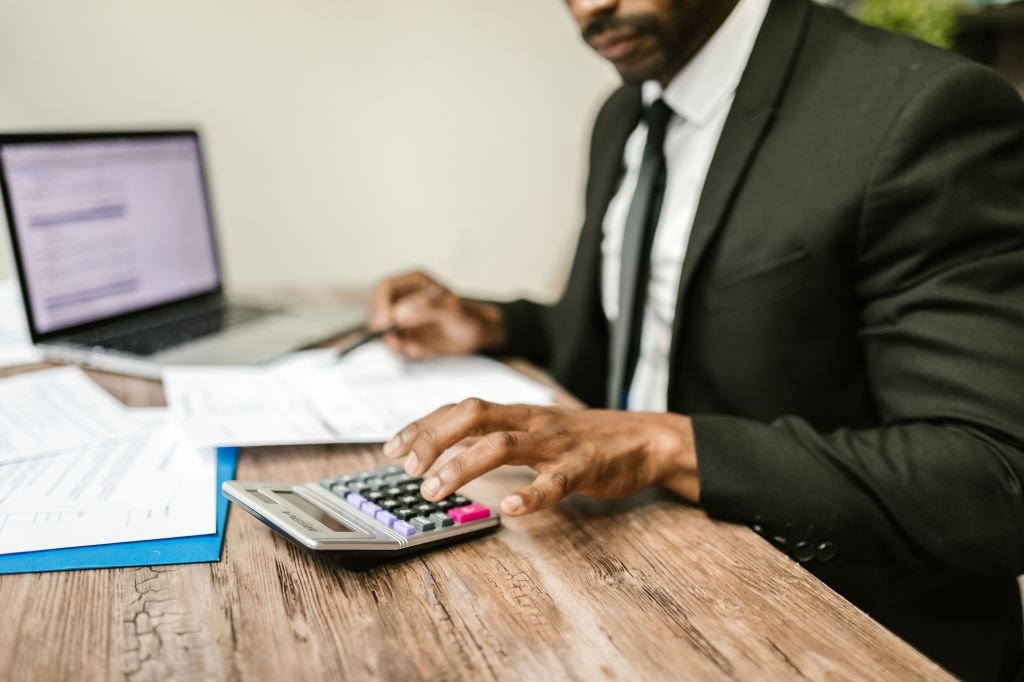 man calculator finance desk