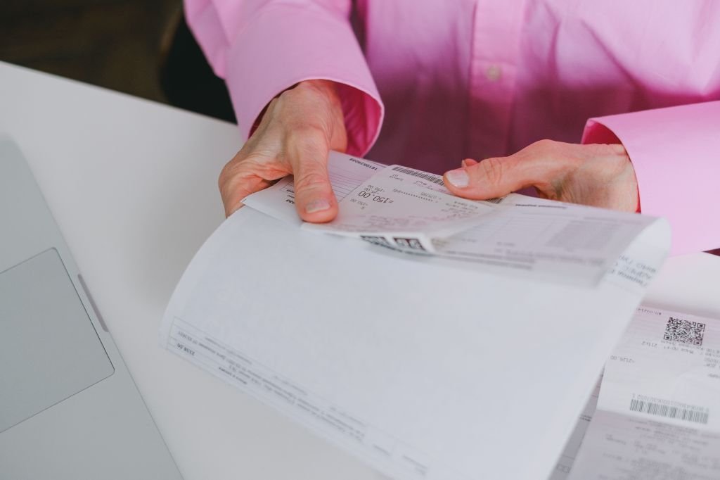 A bank statement and receipts spread out on a desk