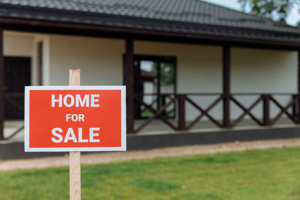 A for sale sign in front of a house